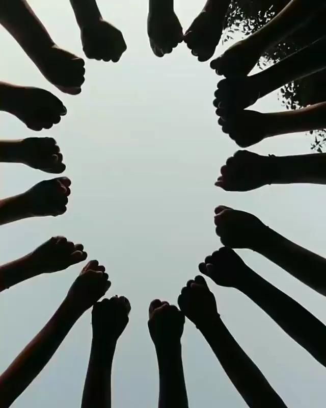 a group of people's feet in the middle of a circle with sky in the background