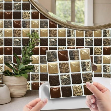 a woman is holding a tablet computer in front of a mosaic tile wall and mirror