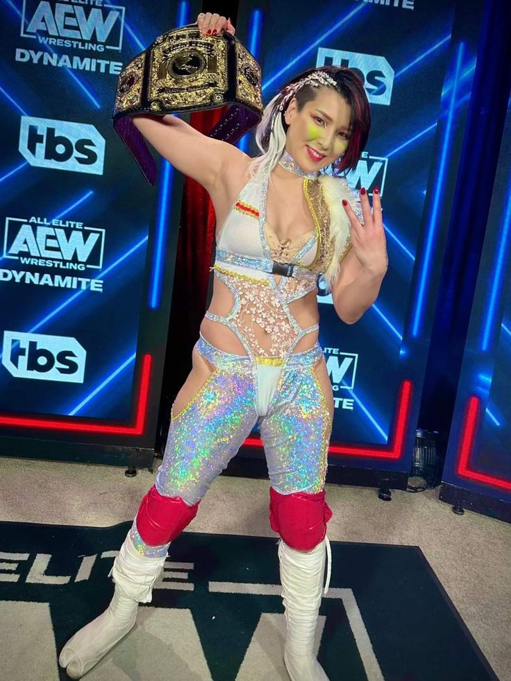 a female wrestler is posing for the camera