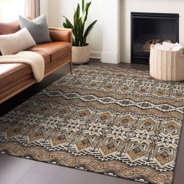 a living room with a couch, chair and rug in front of a fire place