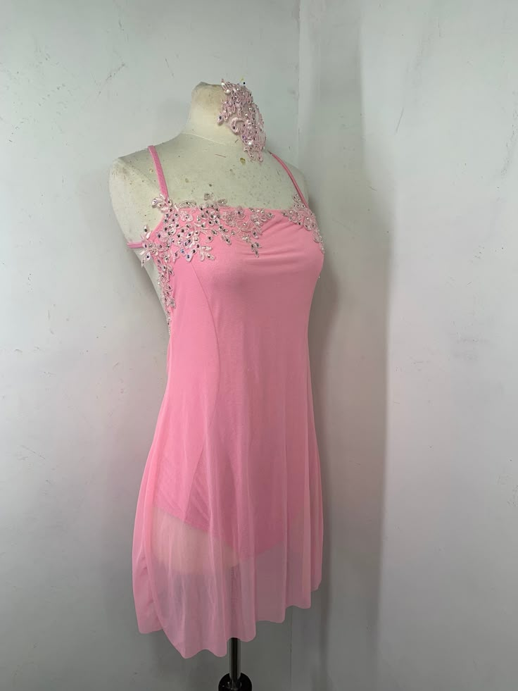 a mannequin with a pink dress on display