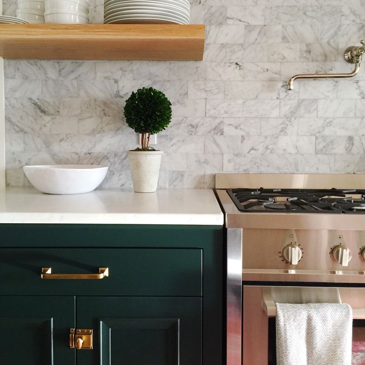 a stove top oven sitting inside of a kitchen