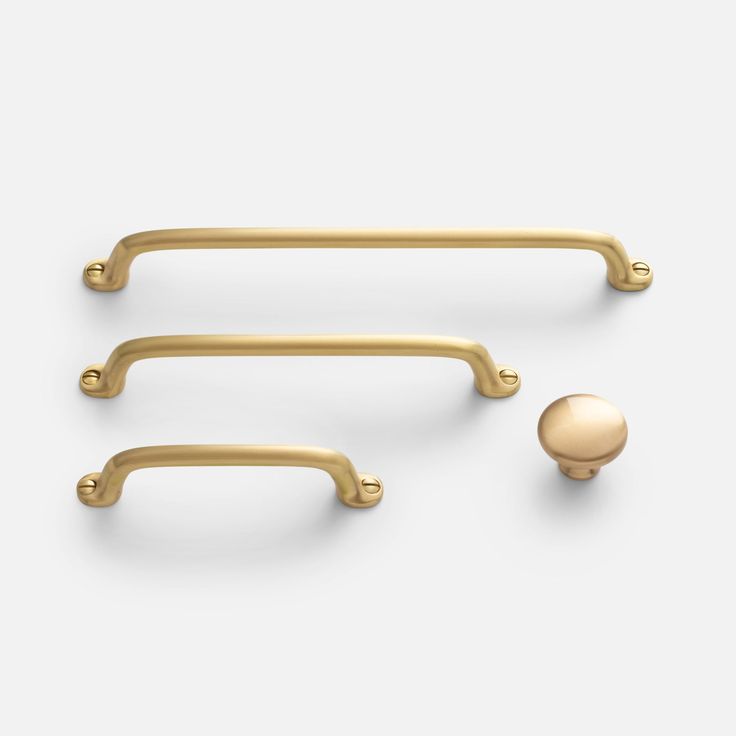 two brass handles and a ball on a white background