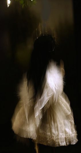 a blurry photo of a woman in a white dress