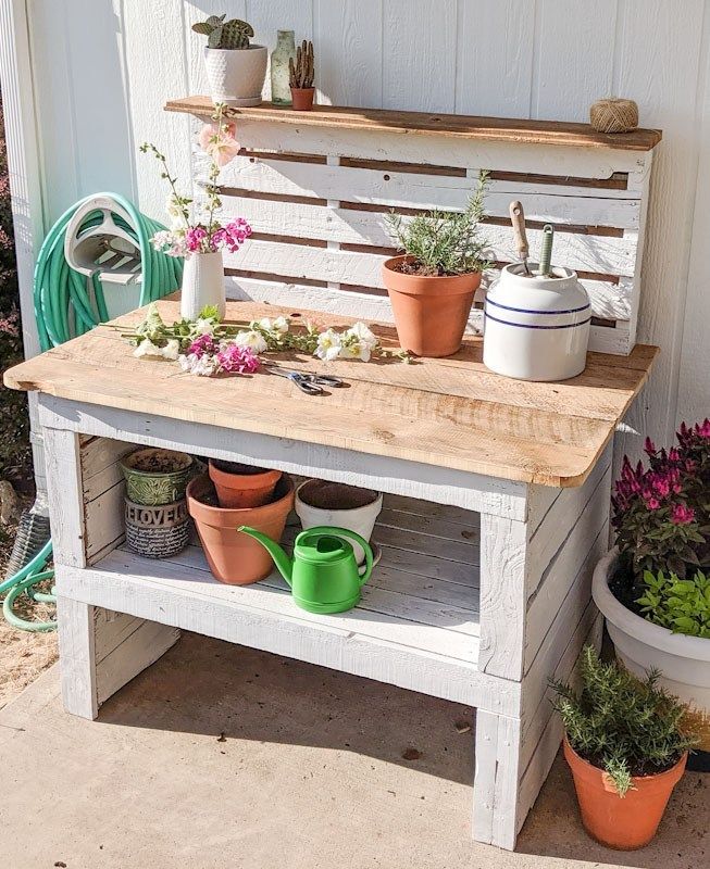 potted plants are sitting on an old bench