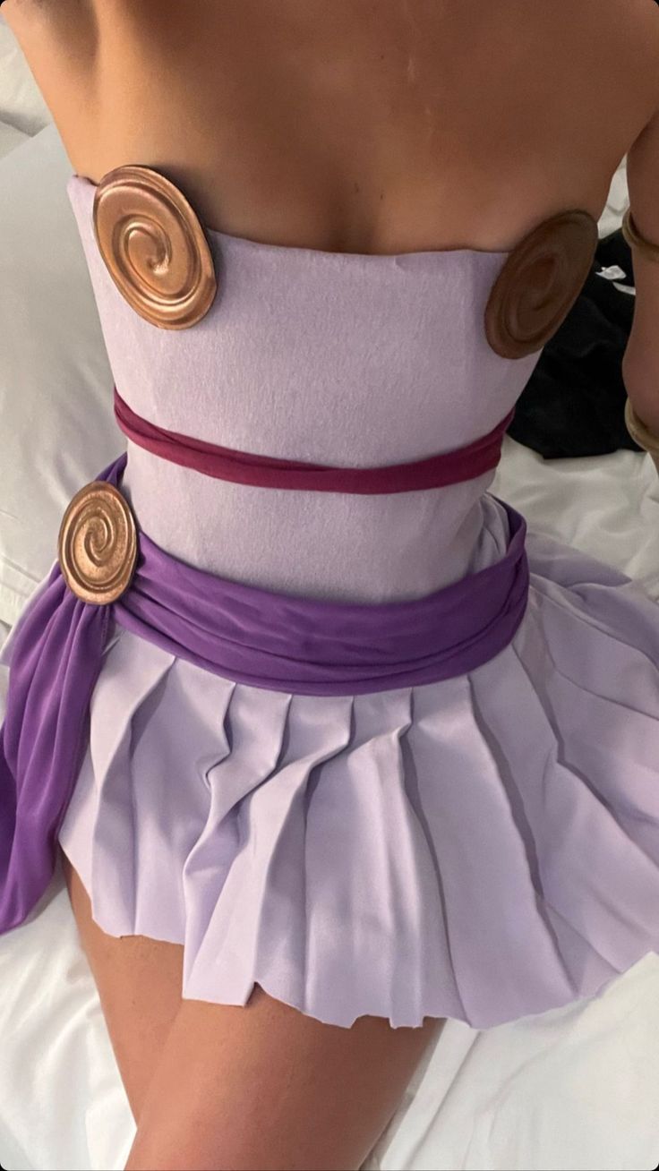 a woman wearing a purple and white corset with buttons on the bottom,