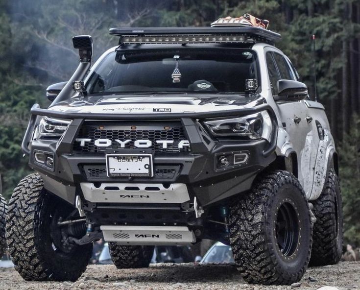 an off - road vehicle is parked in the woods