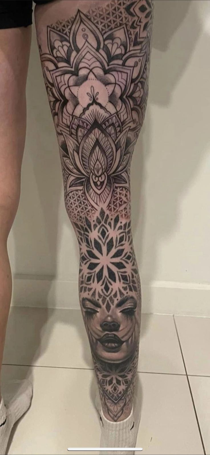 a woman's legs with tattoos on them