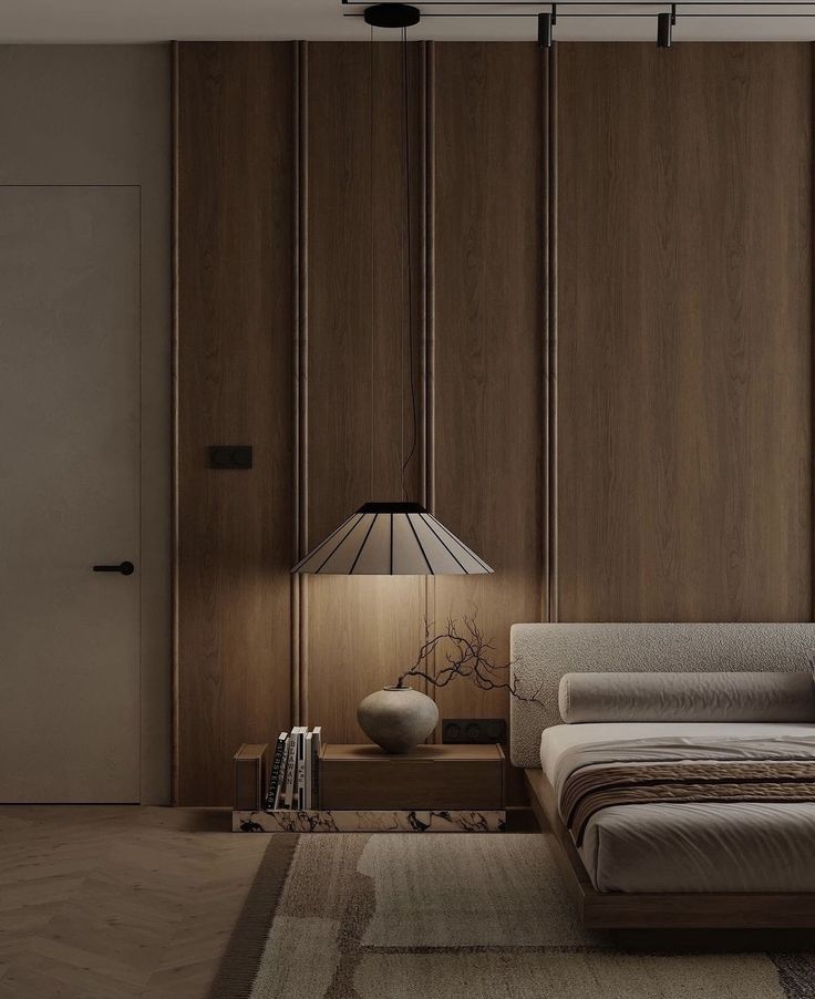 a modern bedroom with wood paneling and a bed in the corner, along with a lamp