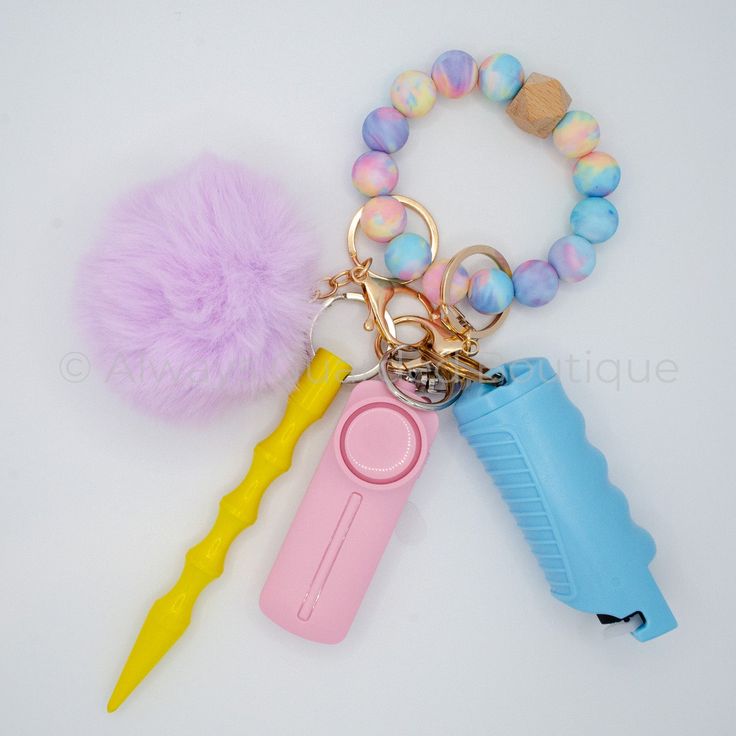 a keychain with some items on it and a pom - pom