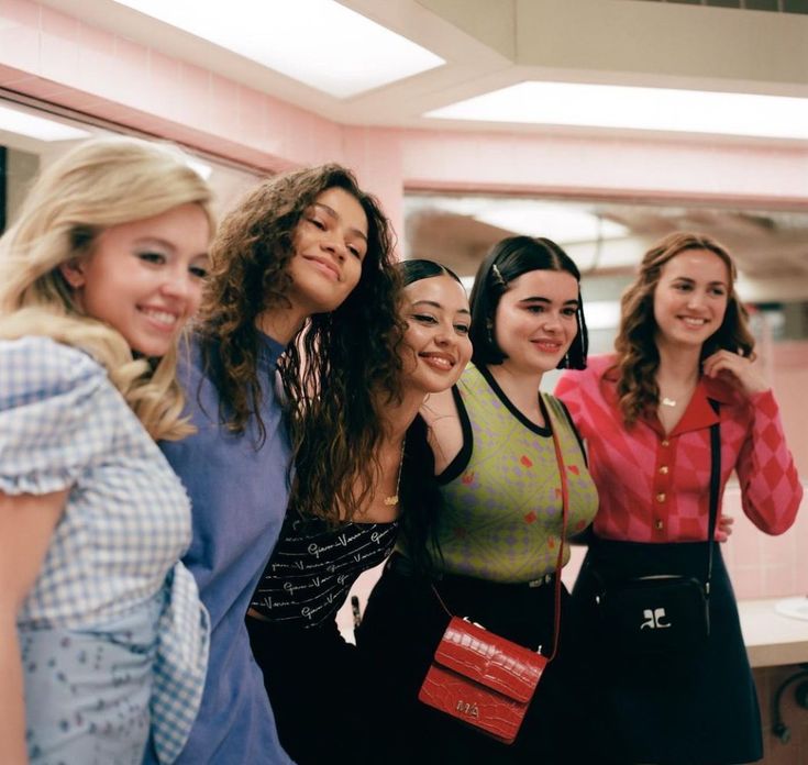 a group of young women standing next to each other