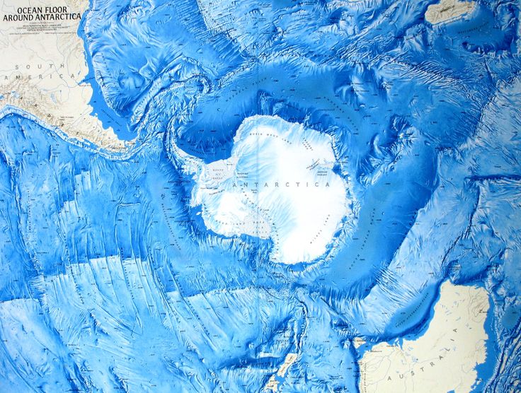 an aerial view of the ocean with blue and white paint on it's surface