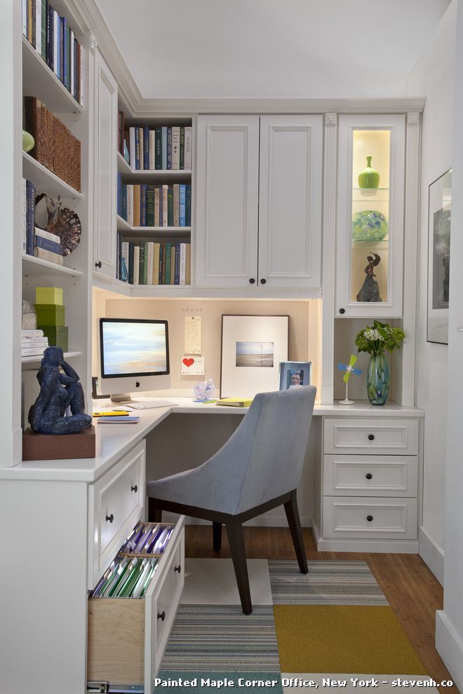 a home office with built in bookshelves and desk