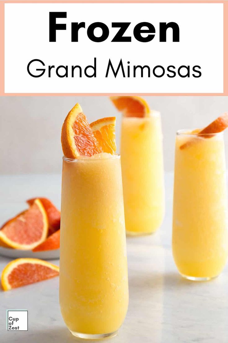 three glasses filled with orange juice and garnished with an orange slice on the rim