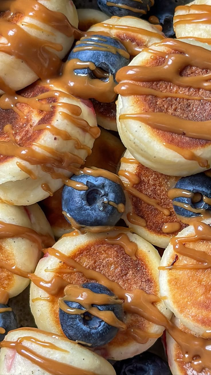 pancakes with blueberries and syrup on them are ready to be eaten in the oven