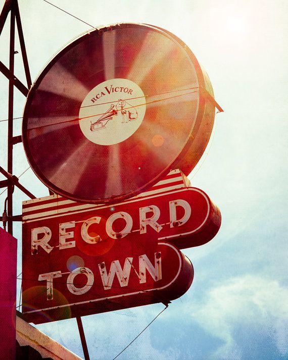 an old record town sign with the word record town on it