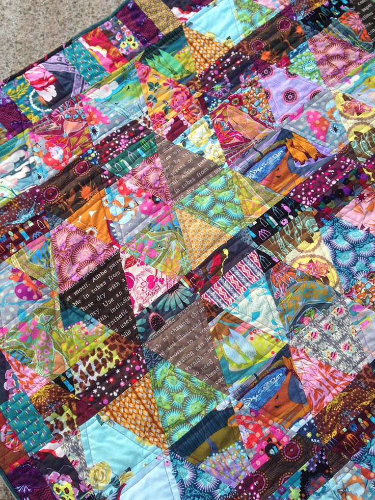 a colorful patchwork quilt on the ground