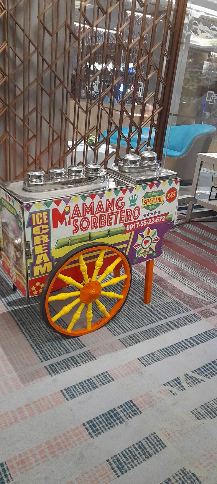 an orange and yellow cart sitting on top of a checkered floor