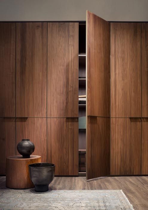 a room with wooden cabinets and a rug on the floor