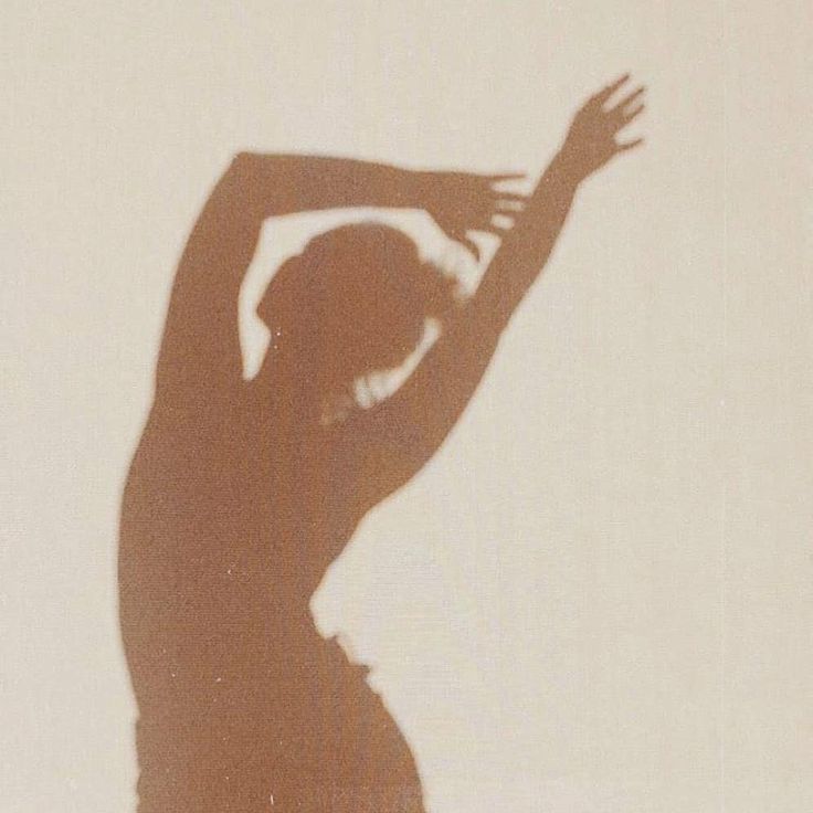 the shadow of a woman is cast on a wall