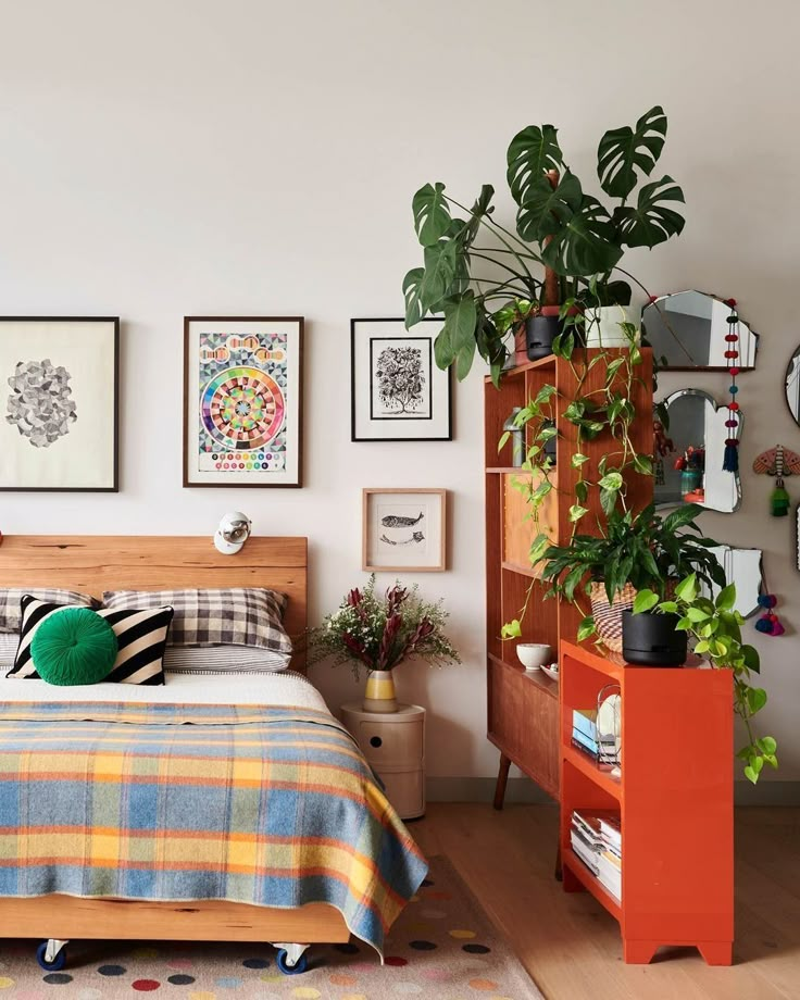 a bed room with a neatly made bed and lots of plants