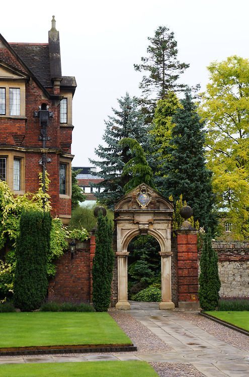 an old brick building with a garden in front