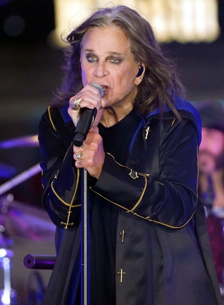 a woman singing into a microphone on stage