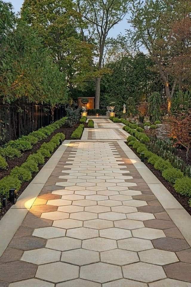 an outdoor walkway is lit up with lights