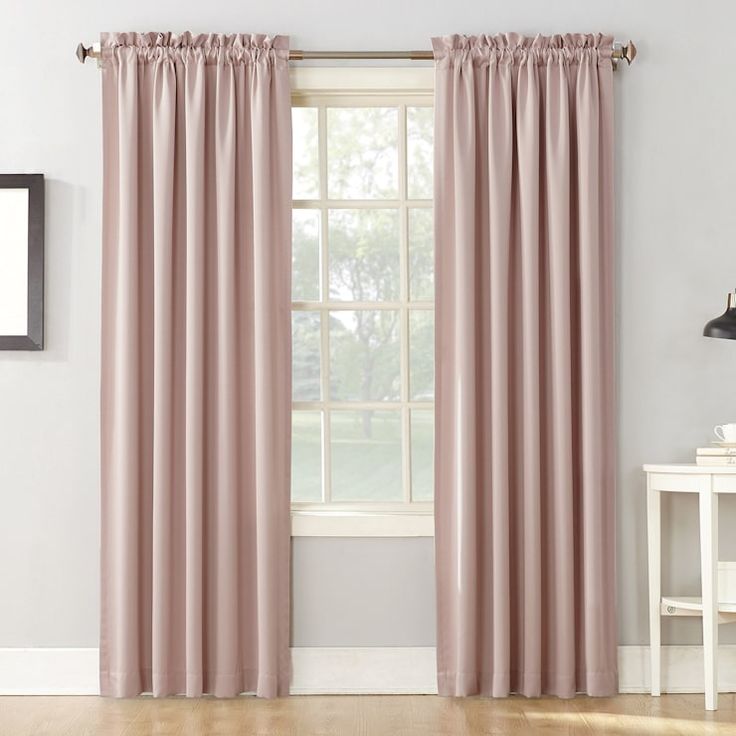 a living room with white walls and pink curtains