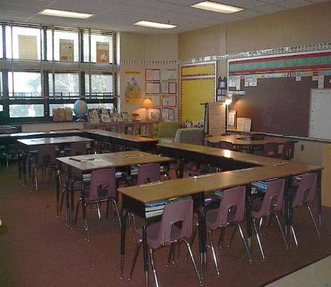 an empty classroom with desks and chairs