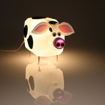 a light that is shaped like a cow with its head turned to look like a pig