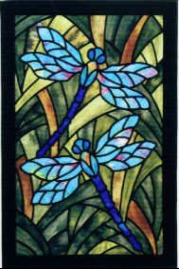 a stained glass window with dragonflies on it