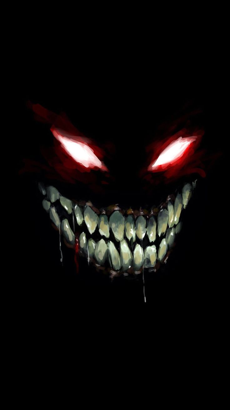 an evil face in the dark with red eyes and fangs on it's teeth