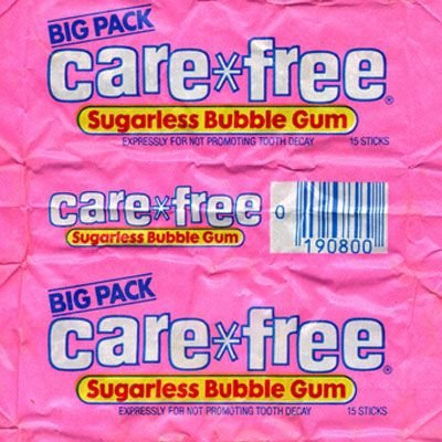 two bags of care - free gum sitting on top of each other in front of a pink background