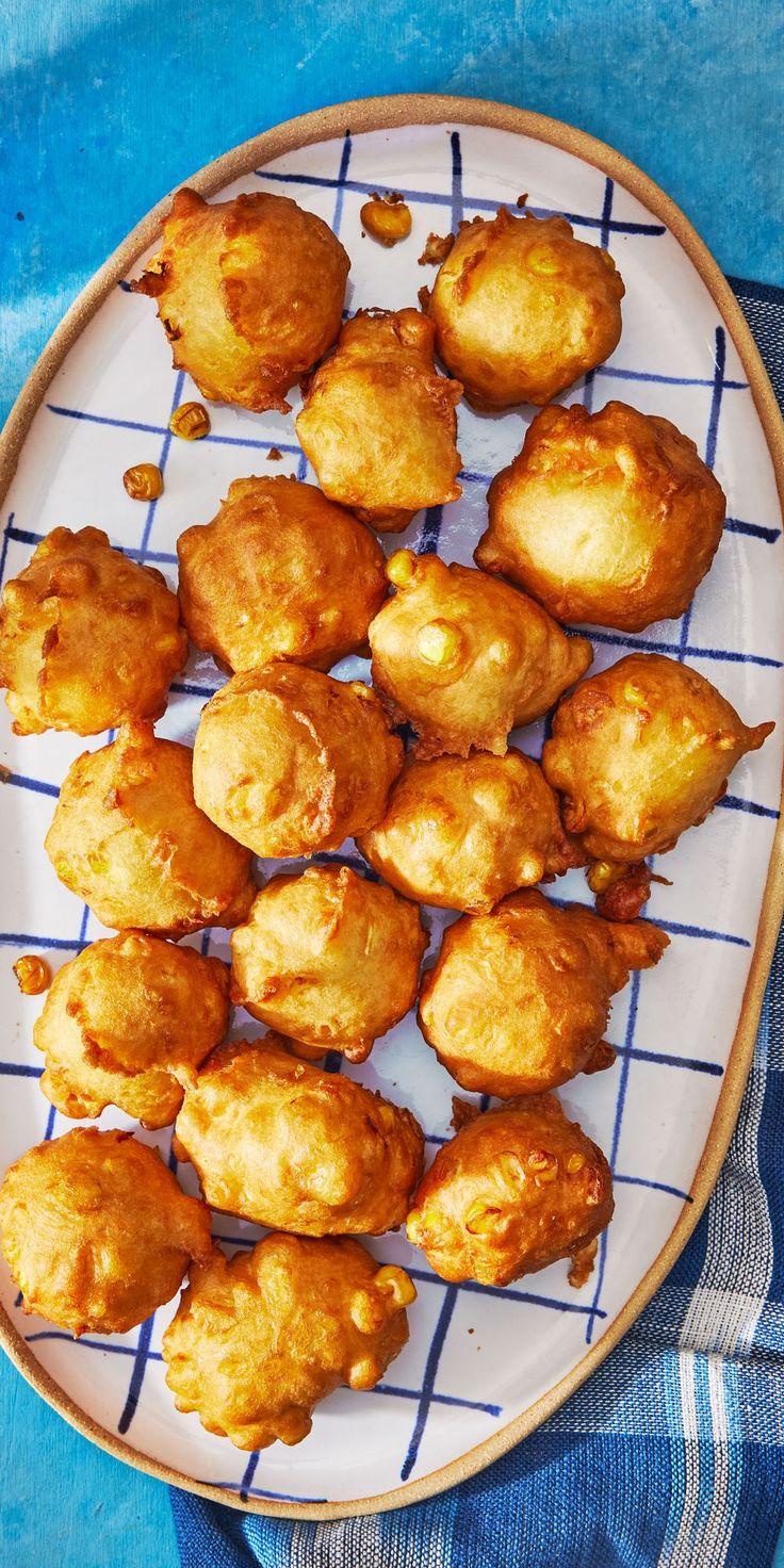 a plate full of fried food on a blue table cloth