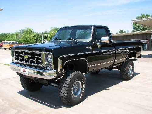 a black pickup truck parked in a parking lot