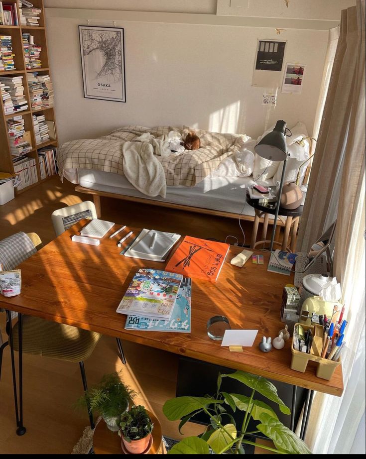 a bedroom with a bed, desk and bookshelf full of books in it