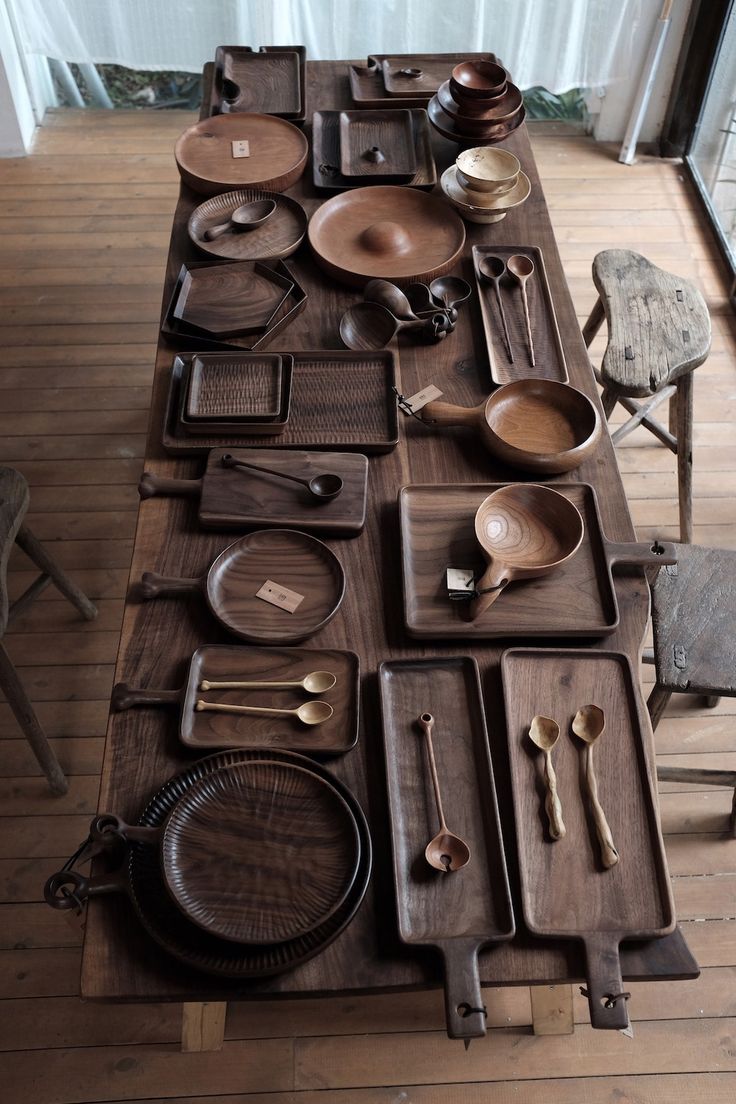 a long table covered with lots of different types of dishes and utensils on it