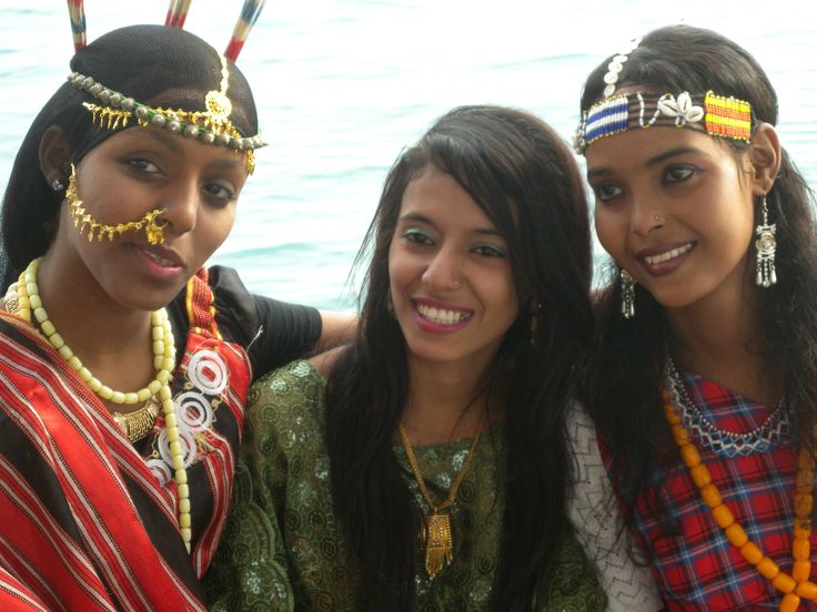 three young women are posing for the camera with beaded headdresses on