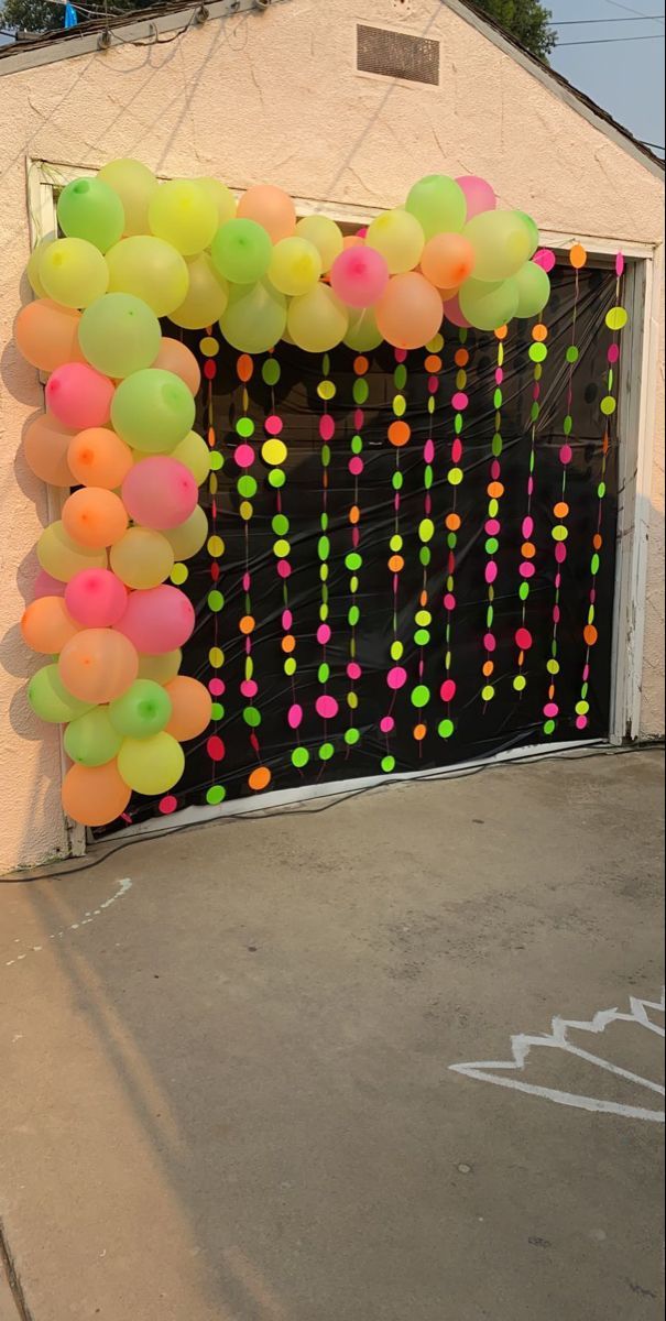 a garage door decorated with balloons and streamers