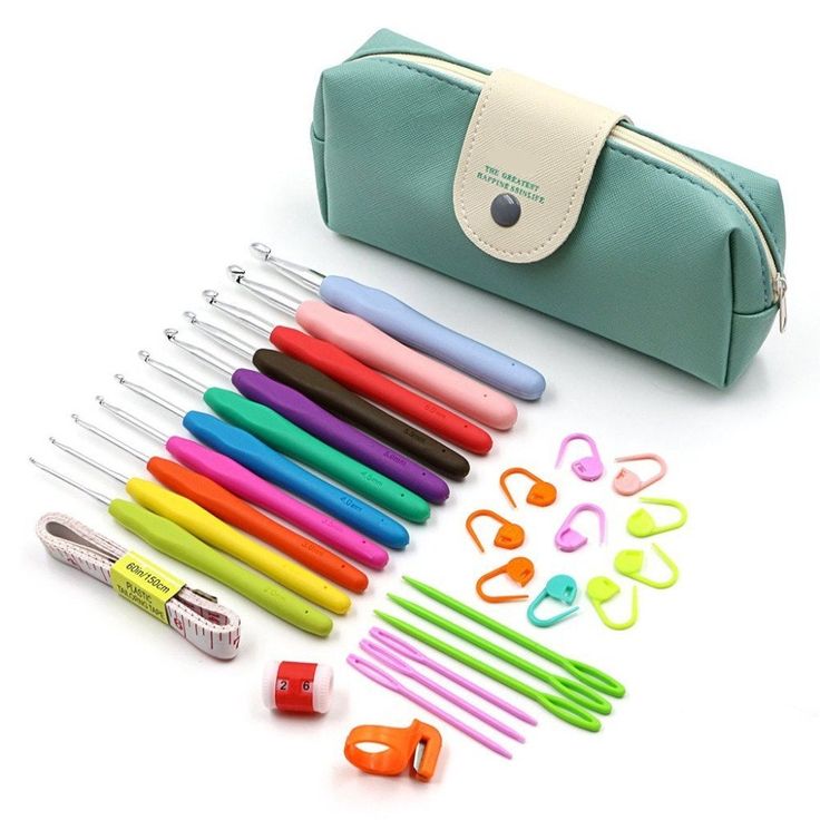 a green case filled with lots of different colored pens and markers on top of a white surface