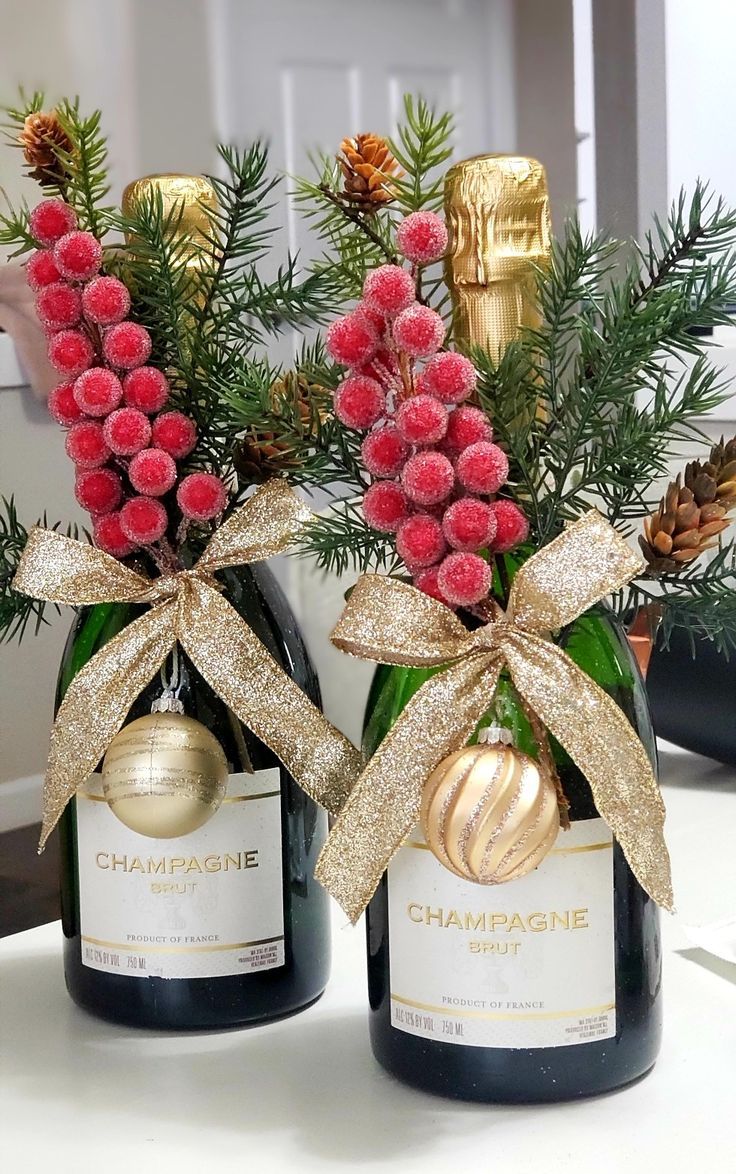 two champagne bottles with christmas decorations on them