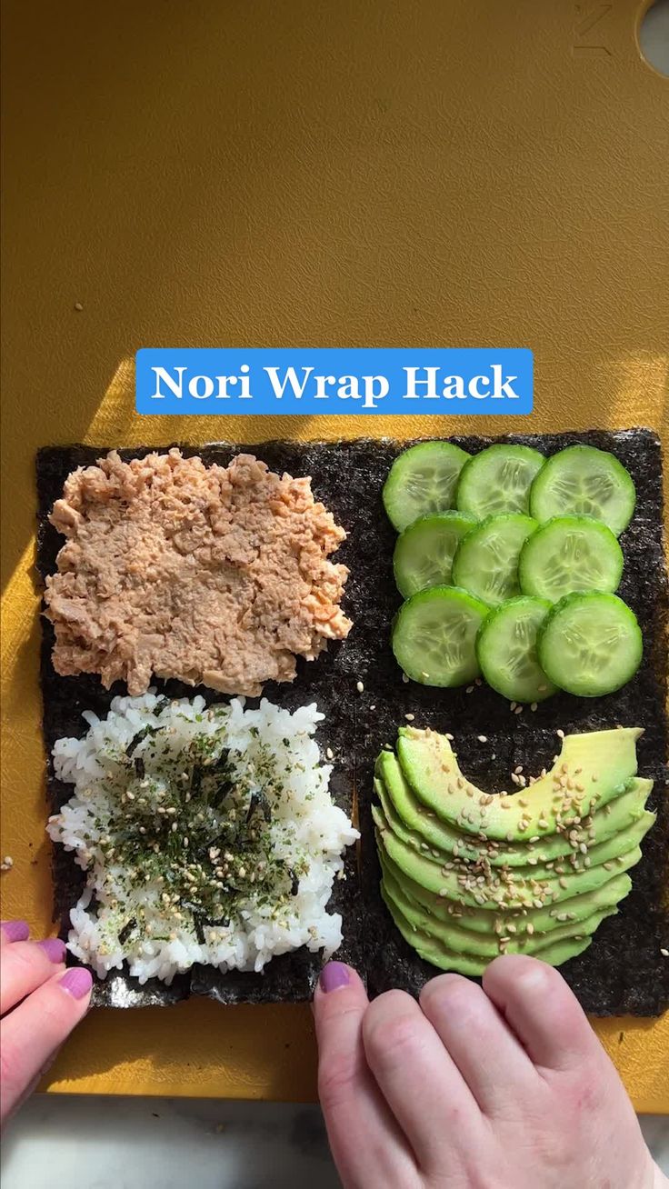 a person is holding up a sushi with cucumbers and rice on it