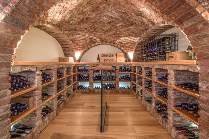 an image of a wine cellar with lots of bottles on shelves and in the middle