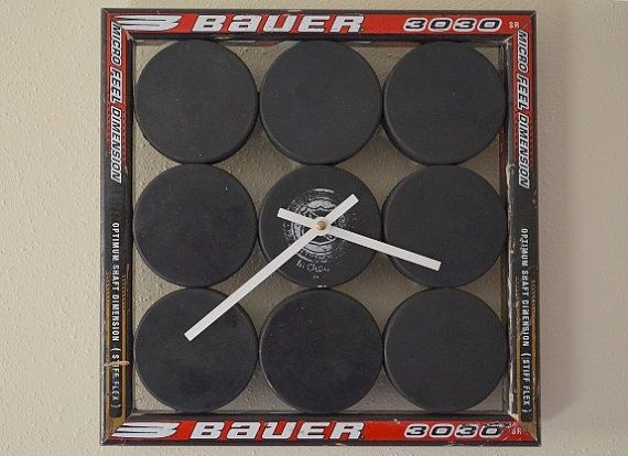 a clock made out of hockey pucks in a box with the numbers on it