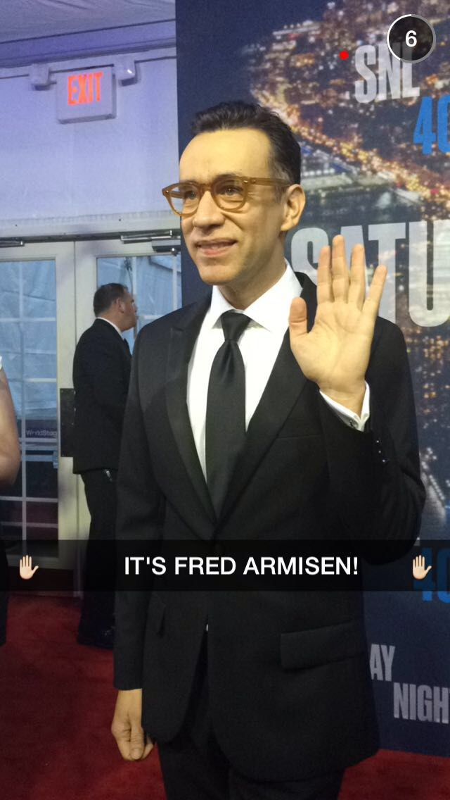 a man in a suit and tie making the vulcan sign with his hand at an event