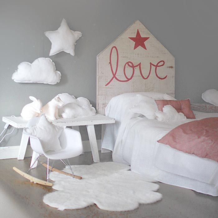 a child's bedroom decorated in pink and white