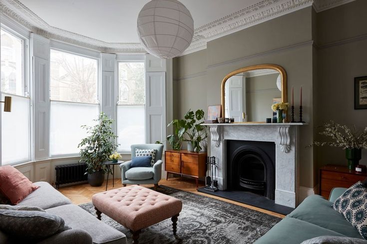 a living room filled with furniture and a fire place in the middle of a room