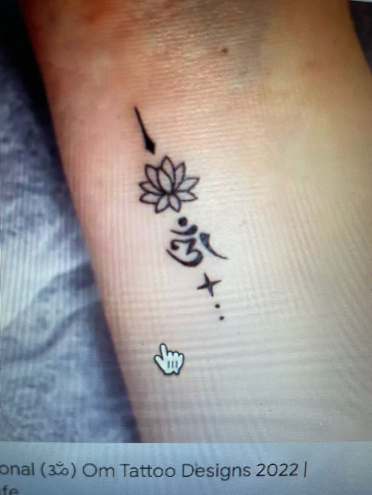 a small tattoo on the ankle with chinese writing and flowers in it's center