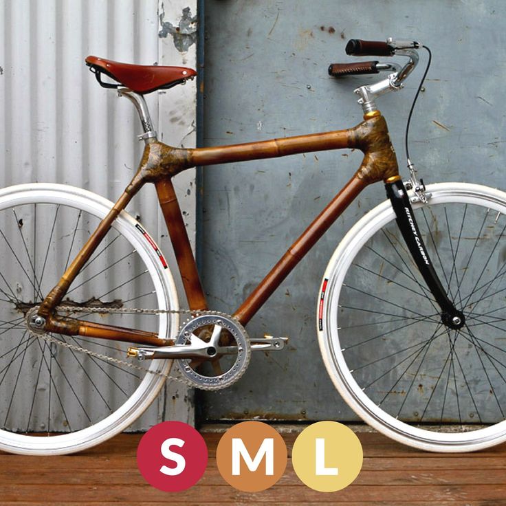 a wooden bike parked in front of a metal door with the words sml on it